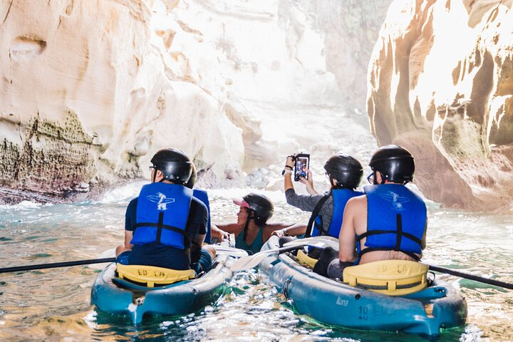 Kayakers with a tour guide inside of Emerald Cave